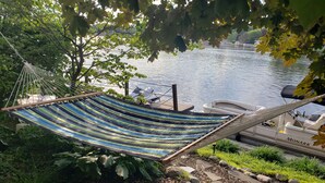 A hammock by a lake with boats and a dock. - Beautiful Waterfront Home on Baugo Bay (Osceola)