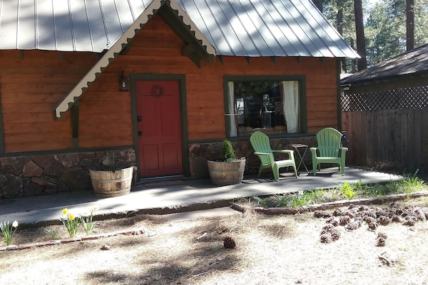 Photo of front porch with seating out front and large picture window