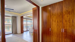 A spacious room with a large wooden wardrobe, a sliding glass door leading to a balcony, and a modern ceiling design. - Designer 2BR w/ Balcony & Pool in Romantic Zone (Puerto Vallarta)
