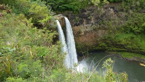 A waterfall surrounded by lush greenery. -  Fresh & Clean, Air Conditioned Second Floor Condo in Princeville  (Princeville)