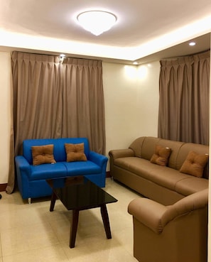 Entire Family Bungalow 3 bedrooms | Living room | 55-inch flat-screen TV with satellite channels, Smart TV, DVD player - Transient House and Van for Rent (Lapu-Lapu)