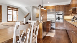 A modern kitchen with wooden cabinets, stainless steel appliances, and pendant lighting. - Outpost: Love Ridge 252 - Spacious, Air Conditioned (Jackson)