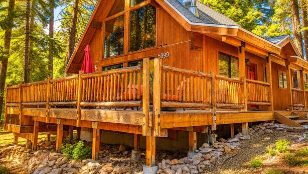 A wooden cabin with a balcony, large windows, and a chimney. - Private Hot Tub in the Pines in North Lake Tahoe (Carnelian Bay)
