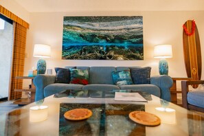 A modern living room with a sofa, two side tables, and a coffee table.