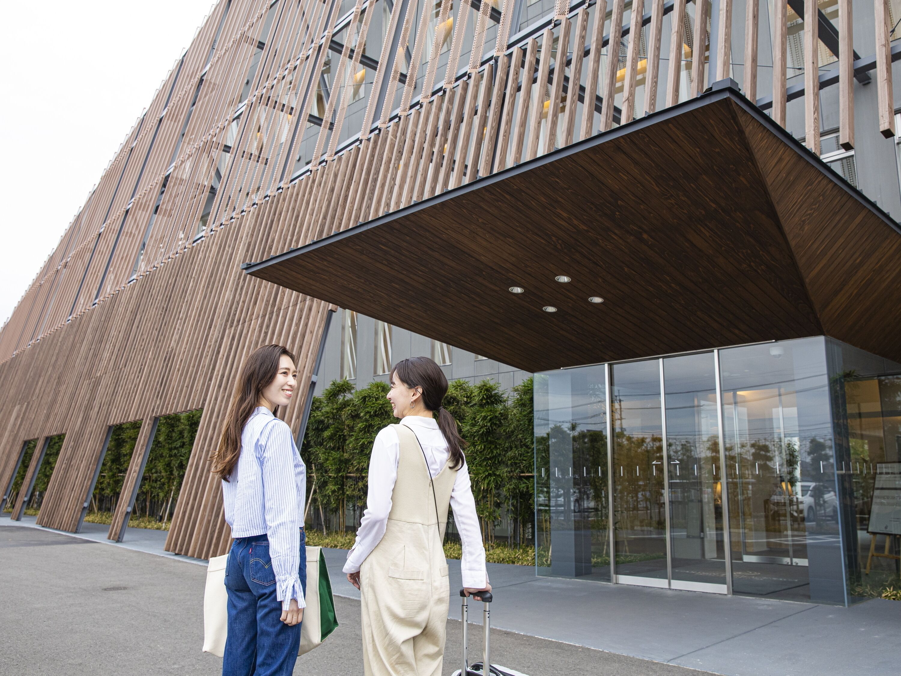 A modern building with a wooden facade and large windows.