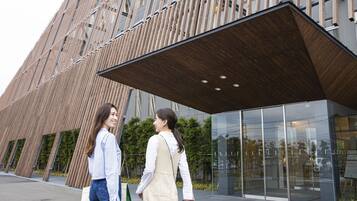 A modern building with a wooden facade and large windows.