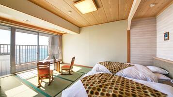 A room with two beds, a desk, and a chair.