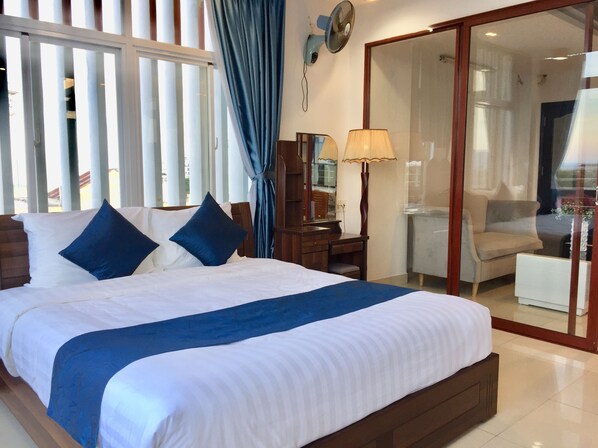 Panoramic Suite, Partial Ocean View | Minibar, desk, laptop workspace, blackout drapes