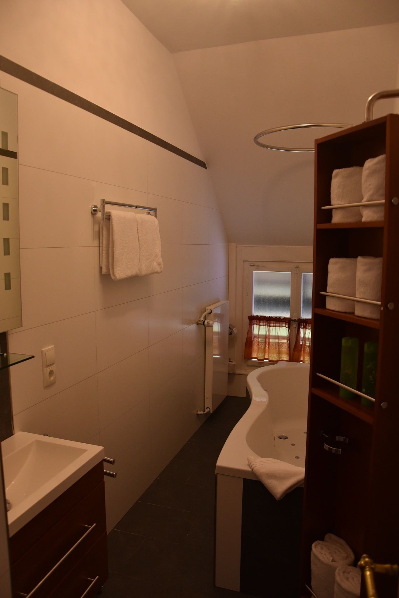 Une salle de bain moderne avec une baignoire sur pieds, un meuble-lavabo et un porte-serviettes.