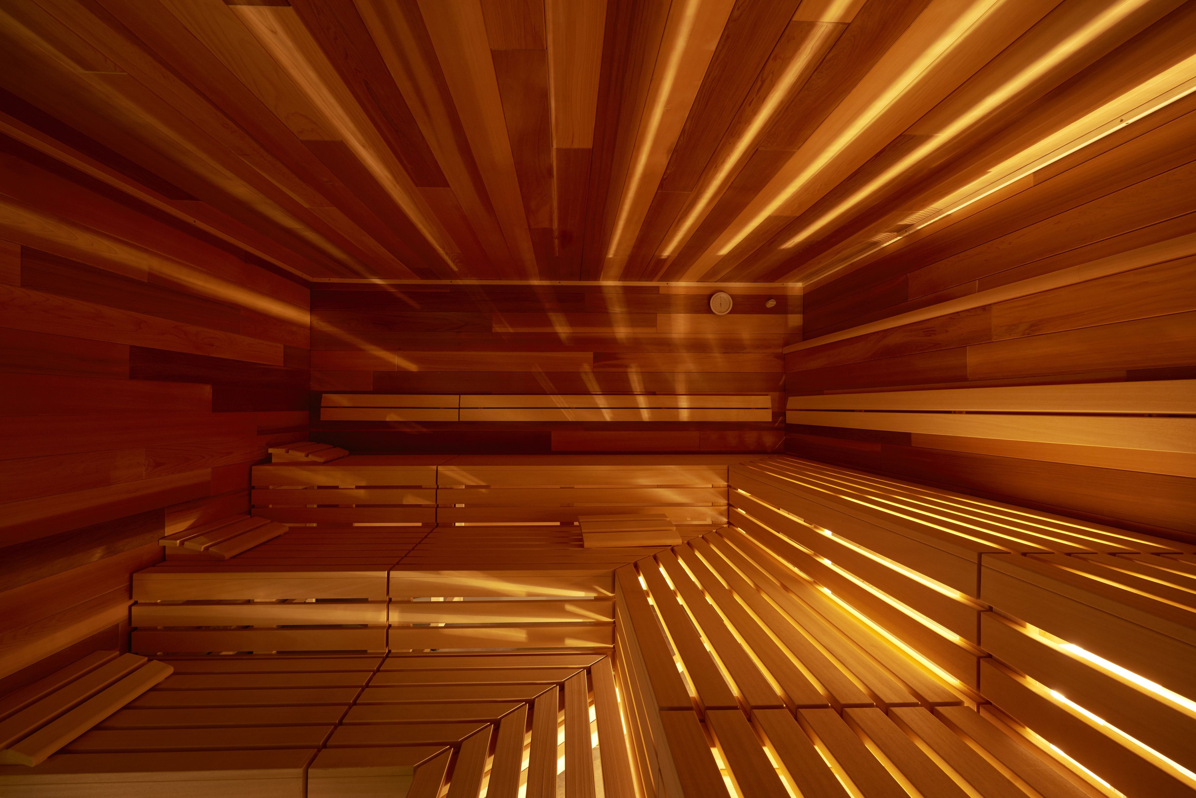 A sauna with wooden benches and slatted walls.