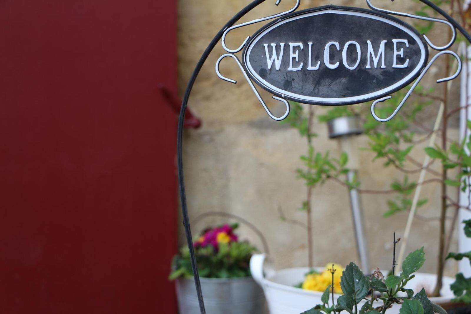 A metal sign with the word "WELCOME" in white letters on a black background.