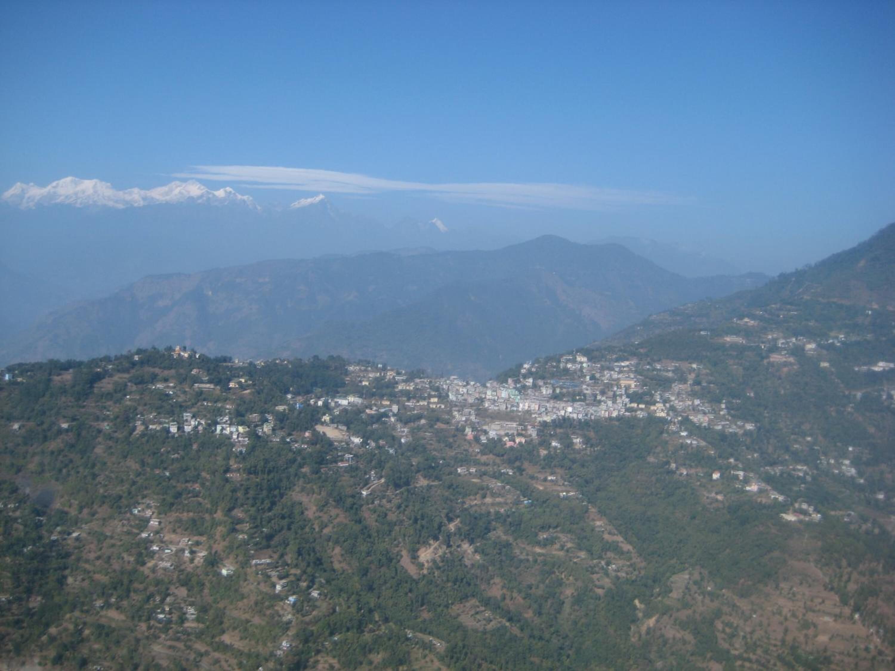 A mountainous landscape with a town nestled in the valley.
