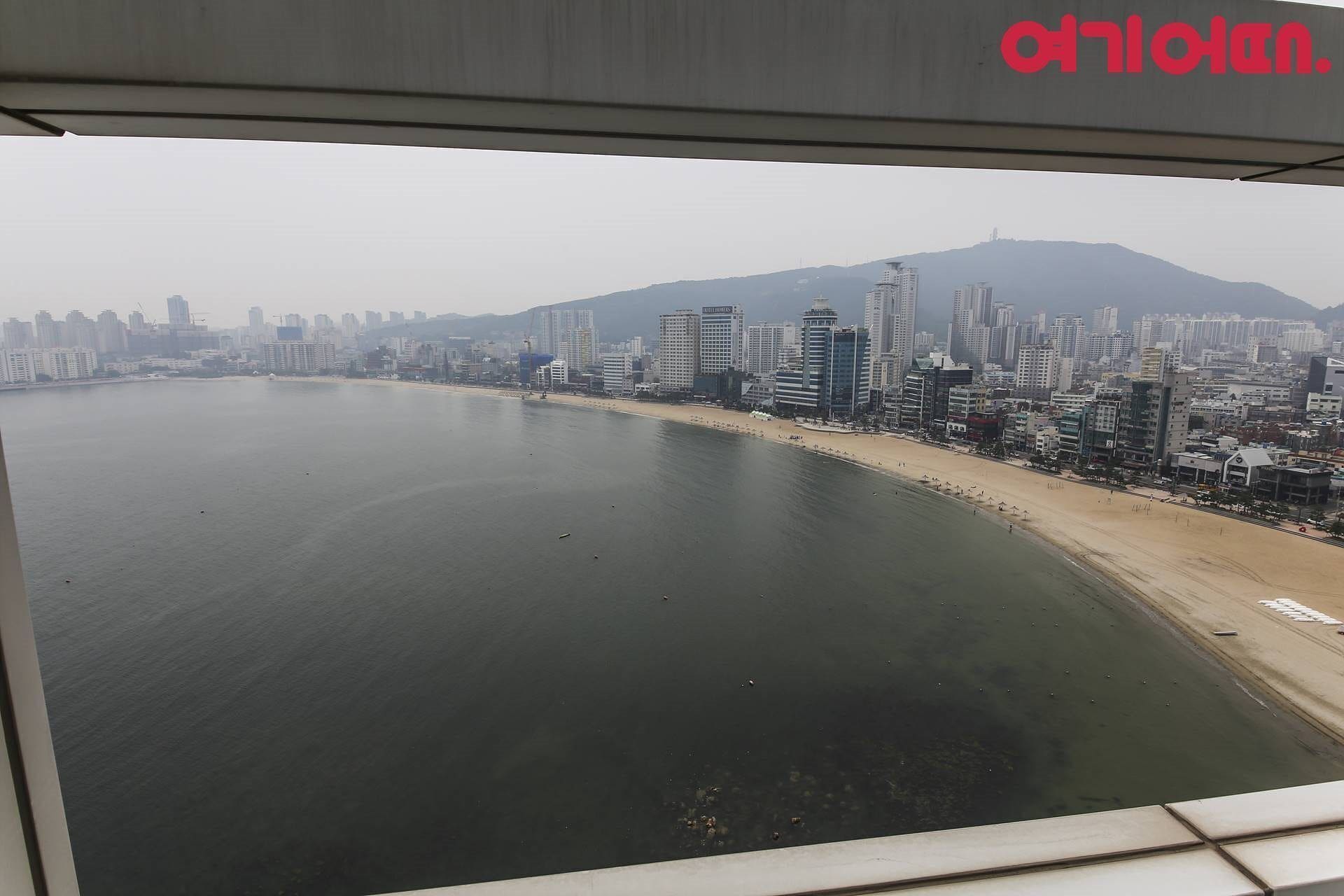 Un paisaje urbano costero con playa y edificios altos.