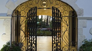 An ornate wrought iron gate with intricate designs, leading to a pathway. - LE RELAIS DE LA POSTE (Magescq)