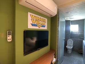 A bathroom with a Wonder Woman sign, a flat-screen TV, and a checkered wall pattern. - Fantastic Hostel (Taichung)
