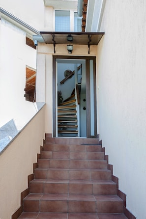 A staircase leading to a door with a metal gate.