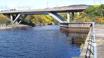 A bridge over a river with a concrete walkway on the right.