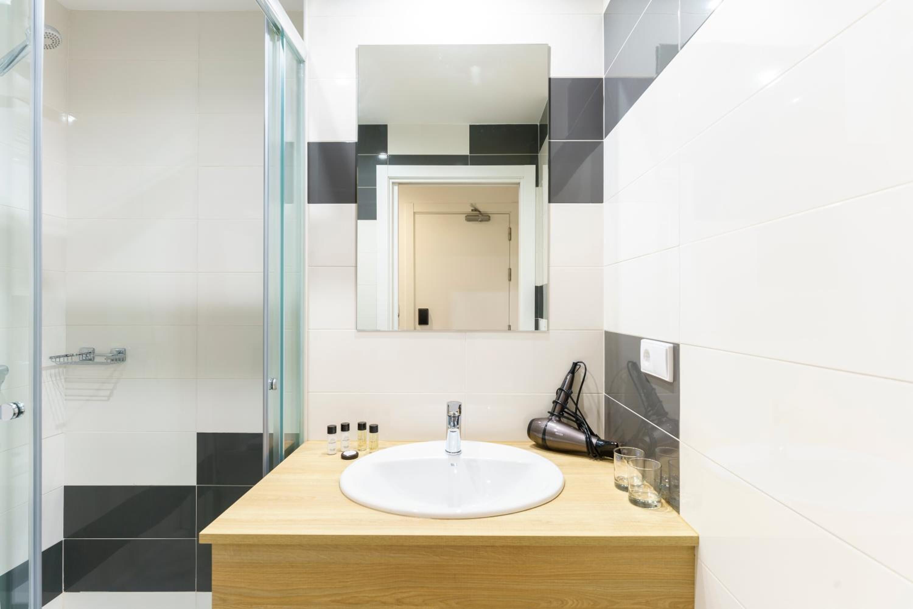 shower, designer toiletries, hair dryer, towels