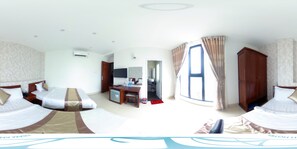 A hotel room with two beds, a desk, a mirror, and a window with curtains. - Tram Anh Hotel (Quy Nhon)