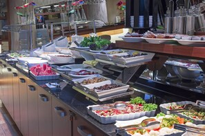 A buffet with various food items and utensils. - The Meretto Hotel Laleli (Istanbul)