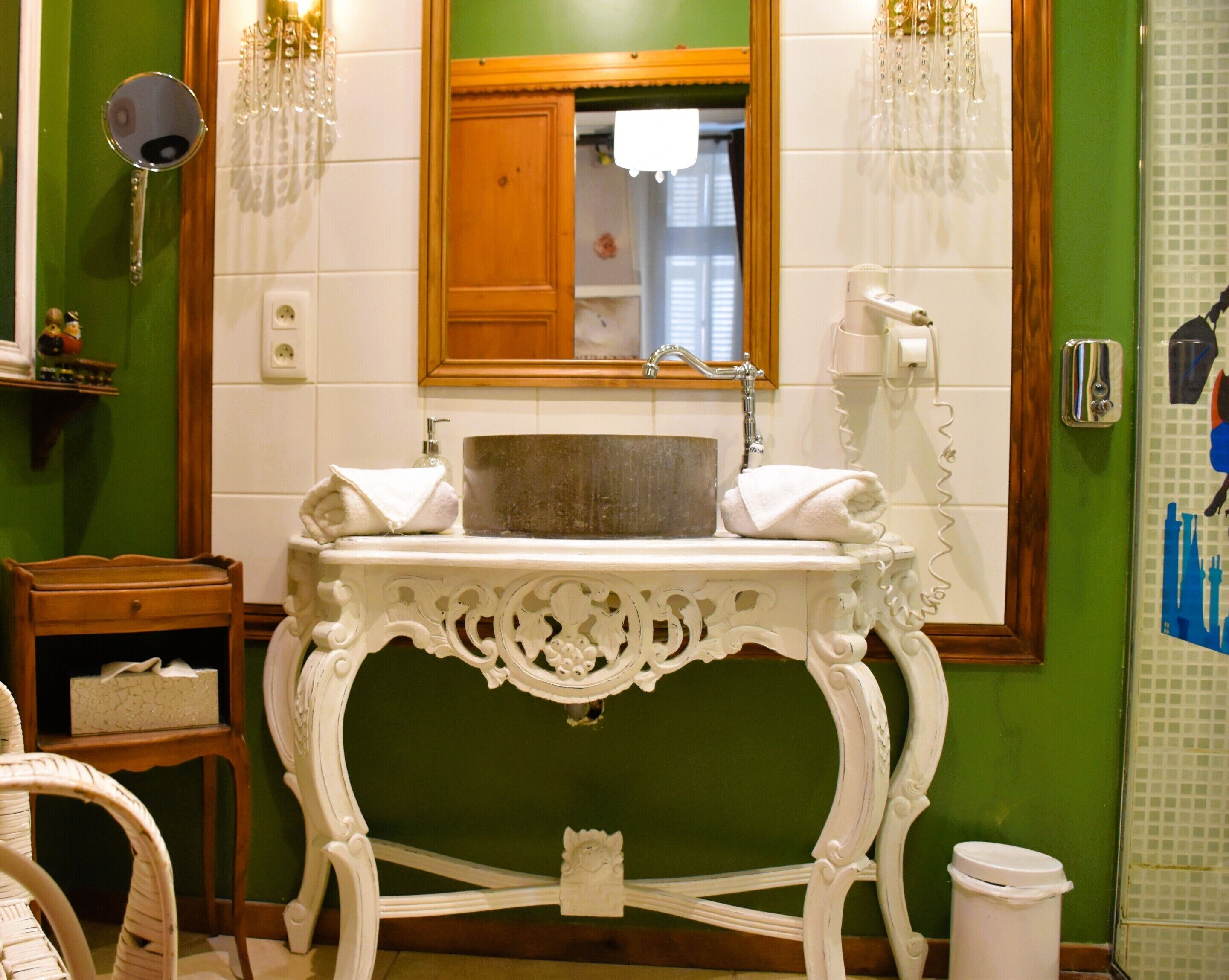 A bathroom with a sink, mirror, and towel rack.