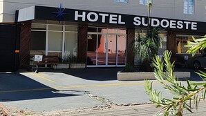 A hotel named "HOTEL SUDOESTE" with a modern facade, large windows, and a visible entrance. - Hotel Sudoeste (Goiania)