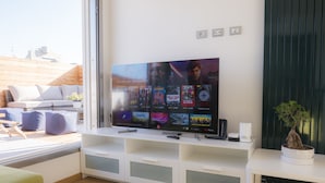 A modern living room with a flat-screen TV mounted on a white entertainment unit. - Immerse Yourself in an Idyllic Situation (Bologna)