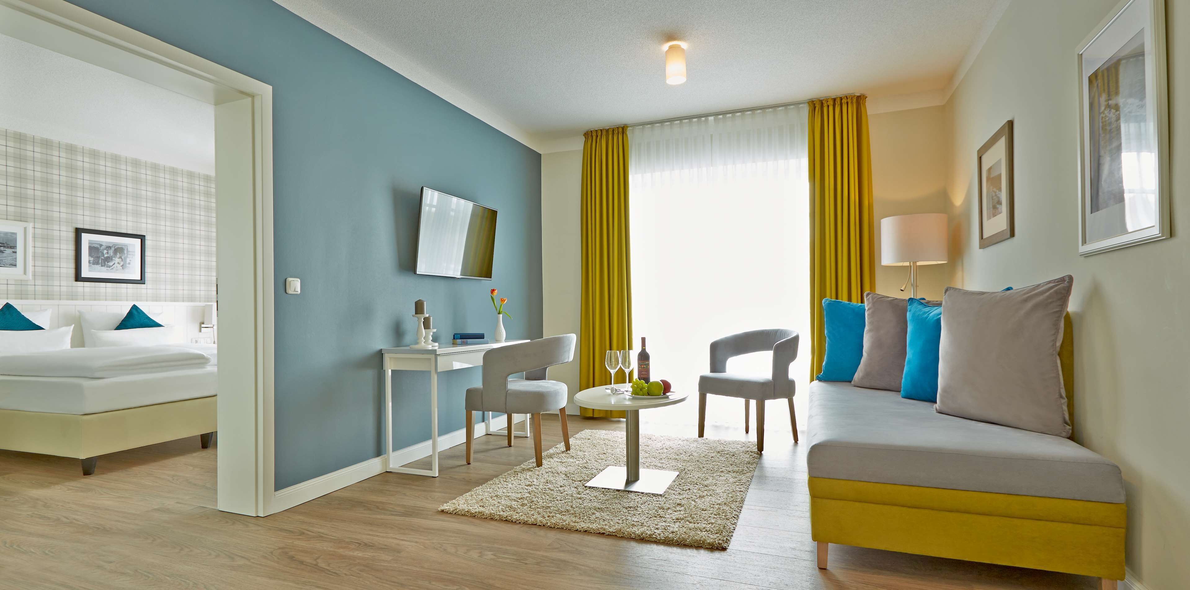 Une chambre d’hôtel moderne équipée d’un lit, d’un bureau, d’un canapé et d’un coin repas.