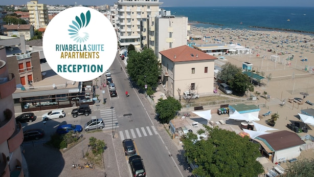 An aerial view of Rivabella Suite Apartments Reception with a beach and cityscape in the background.