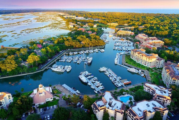 Stunning marina surrounded by lush greenery and residential buildings, offering a scenic waterfront experience.