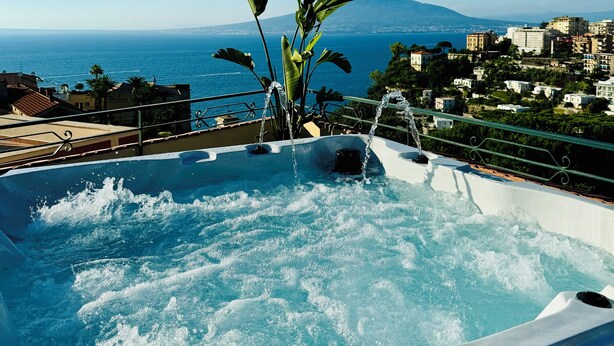 A hot tub with a view of the sea and a mountain in the background. - Vesuvio View (Vico Equense)
