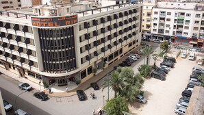 A multi-story hotel with a prominent 'HOTEL RIF' sign, a parking lot, and surrounding buildings.