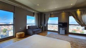 Luxury Room, City View | Living area | Flat-screen TV