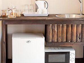 Fridge, microwave, coffee/tea maker, cookware/dishes/utensils