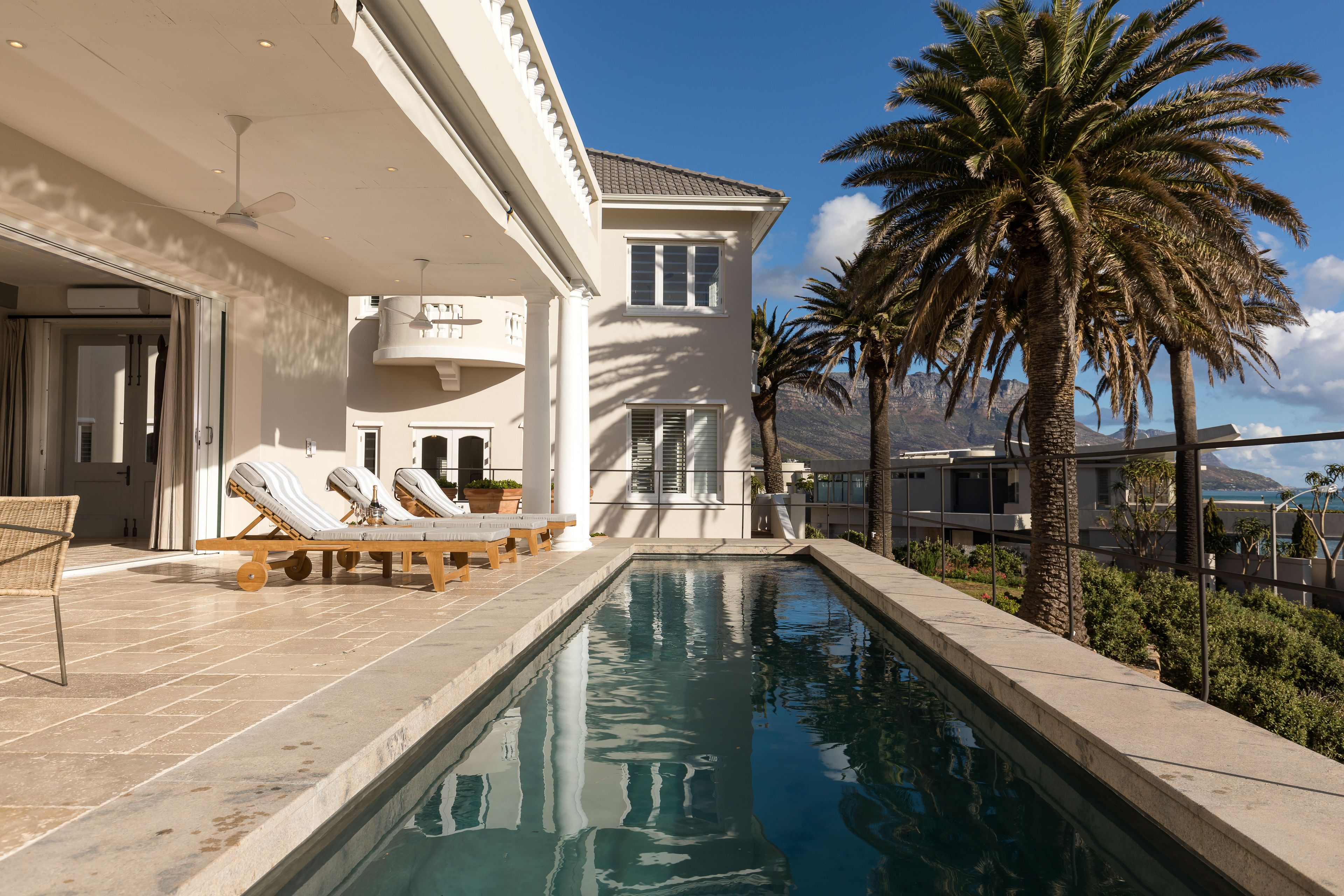 A poolside area with lounge chairs and a clear view of the pool.