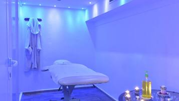 Experience serenity in this spa room, featuring a treatment table, robes, and a tranquil space for relaxation.