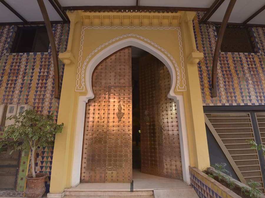 A traditional entrance with a large, ornate door and a decorative archway.