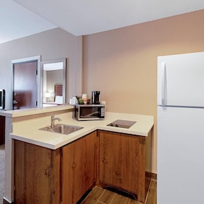 A compact kitchen with a microwave, sink, and refrigerator. - Comfort Inn and Suites (Fredericksburg)