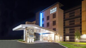 A hotel entrance with a modern design, a stone pillar, and a sign for Fairfield Inn & Suites by Marriott. - Fairfield Inn & Suites by Marriott Fort Morgan (Fort Morgan)