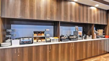 A breakfast bar with wooden cabinets, a toaster, and various food items.