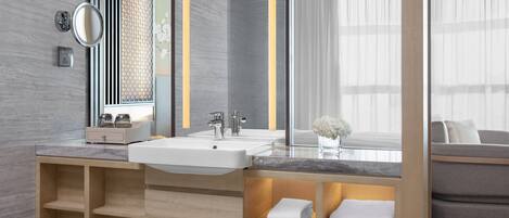 A modern bathroom with a large mirror, two sinks, and built-in shelves for towels.