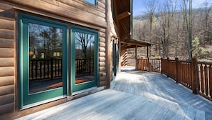 A wooden cabin with large windows and a wooden deck. - Luxurious Woodstock Home Rental Catskill Mountains Views & Private Retreat (Bearsville)