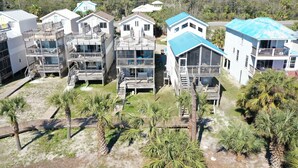 A beachfront property with multiple two-story buildings, each featuring balconies and a pool area. - Beachfront, Spacious, Community Pool, Pet Friendly! 2-The-Beach (Indian Pass)