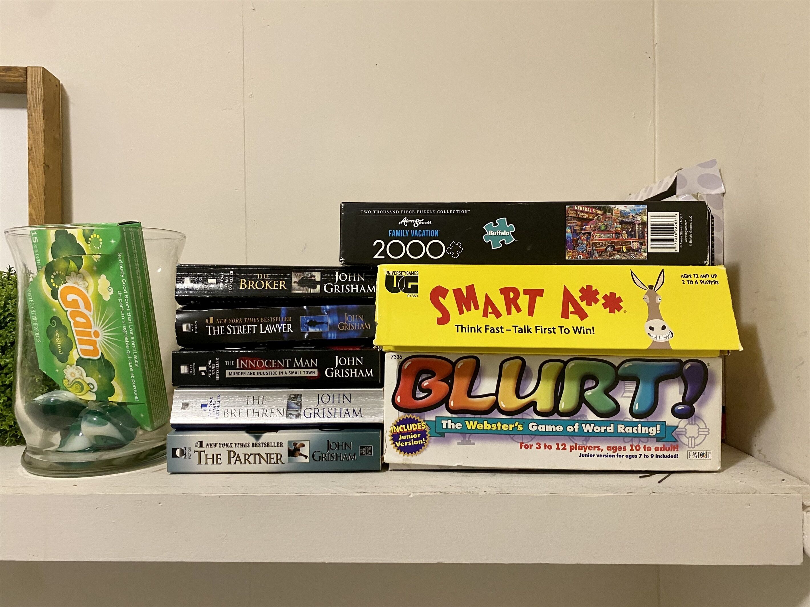 A shelf with various books and a puzzle box.