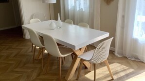 A modern dining area with a white table and chairs, a floor lamp, and a decorative wall piece. - PRETTY PROVENCAL VILLA WITH POOL (Le Tignet)
