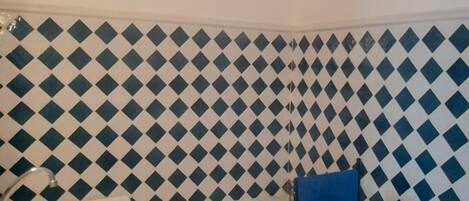 A bathroom with a white sink, a bathtub, and a toilet.