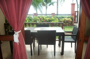 Enjoy a dining experience in a serene garden setting with a table for four.