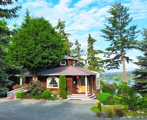 Enjoy a serene retreat surrounded by lush greenery and a picturesque view of the surrounding landscape.