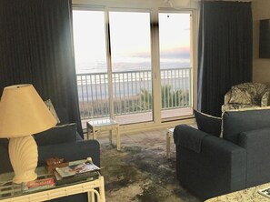 Enjoy the serene sea view from the comfort of your room, where a stylish table and two armchairs invite relaxation.