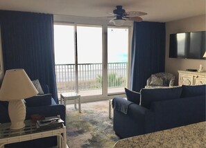 Enjoy stunning ocean views from the comfort of your room, featuring a sofa, table, and TV.